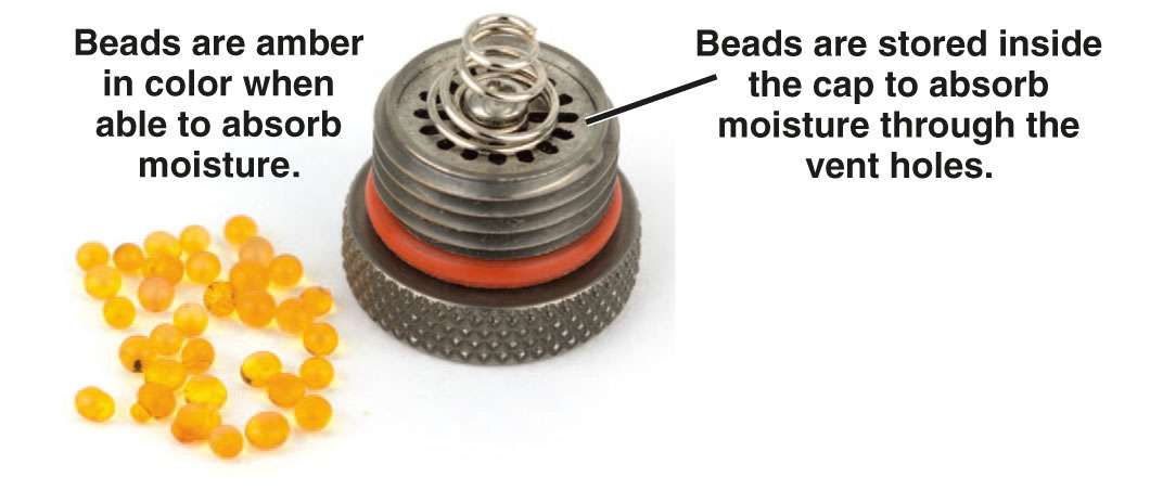 Amber desiccant beads next to a SB1007 WM desiccant battery cap.