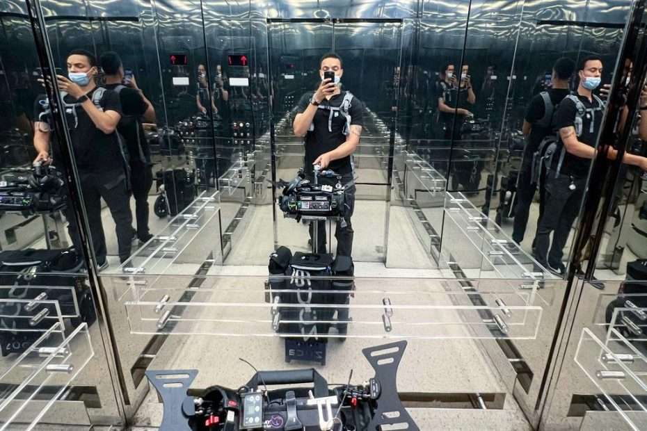 Sound mixer Henry French with Lectrosonics gear in a mirrored elevator