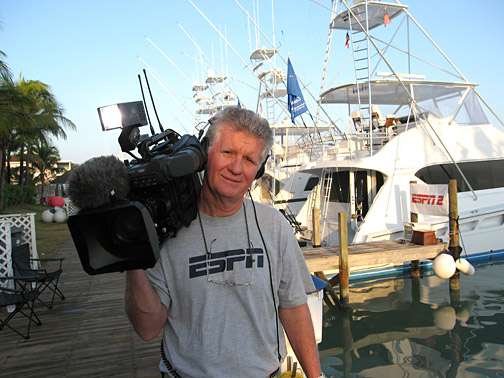 ESPN cameraman with professional video camera on a boat dock
