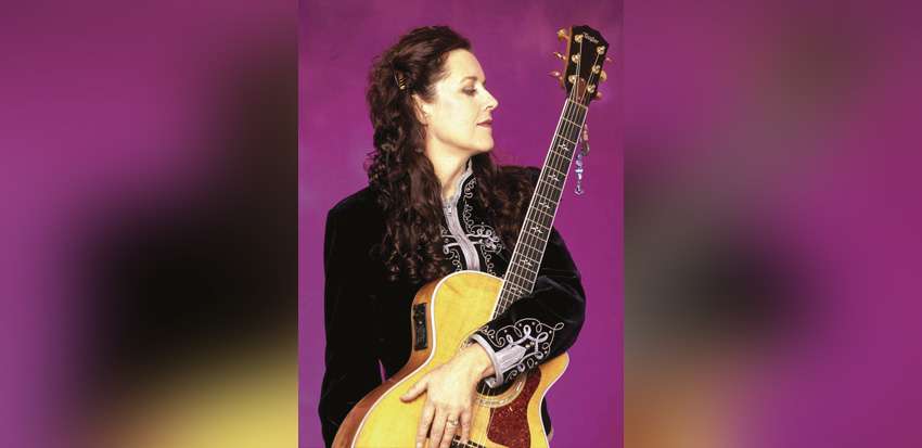 Bonnie Raitt with her acoustic guitar, a performer at Carnegie Hall