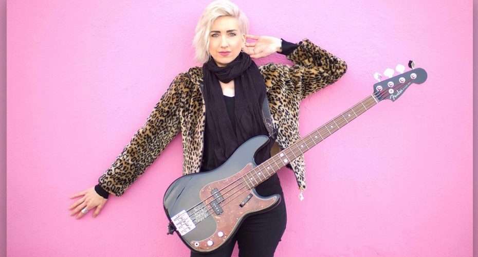 Bassist Eva Gardner in leopard print jacket with pink Fender bass