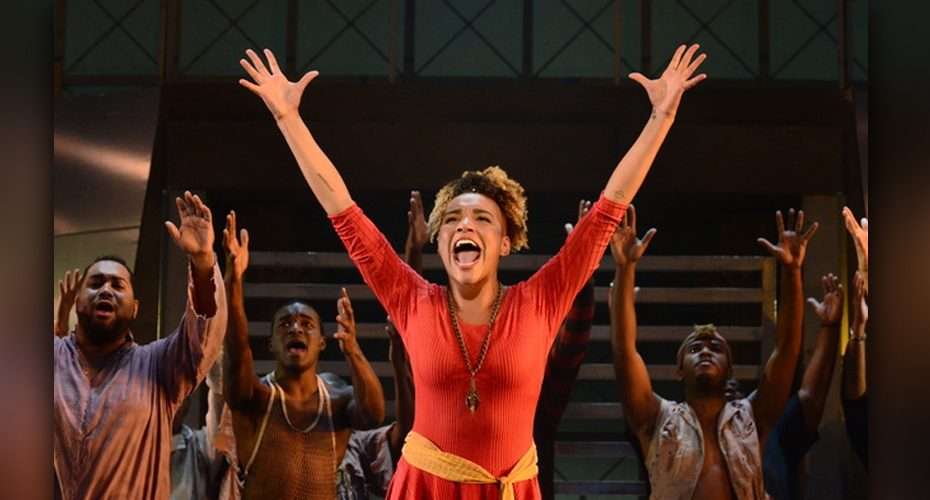Pittsburgh Civic Light Opera performers with arms raised in a musical theater production.