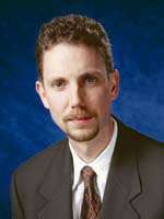 Portrait of a man with a goatee and mustache, likely Winkler, hired by Lectrosonics.