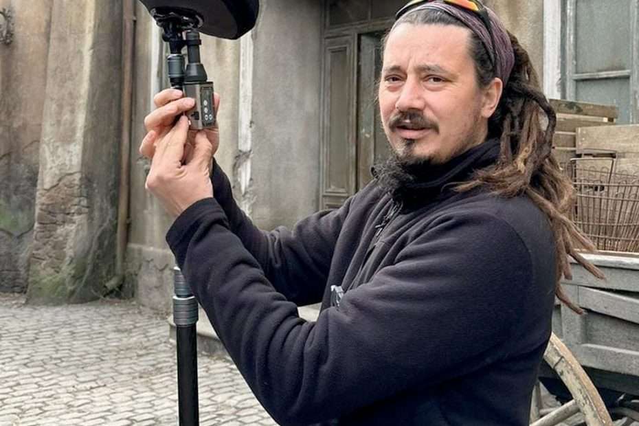 Liviu Lupsa adjusts Lectrosonics audio gear on Wednesday set