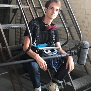 Desert-Heat2 Will Harrell, sound recordist, with boom pole and Lectrosonics gear on stairs