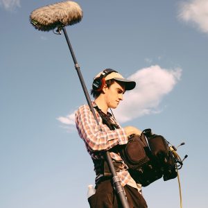Desert-Heat3 Will Harrell with boom mic and sound gear, capturing sound outdoors.