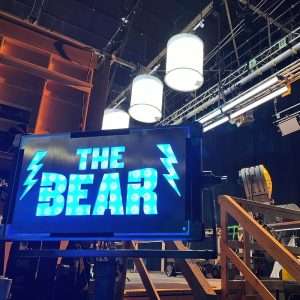 The Bear TV show title screen with lightning bolts on a film set.